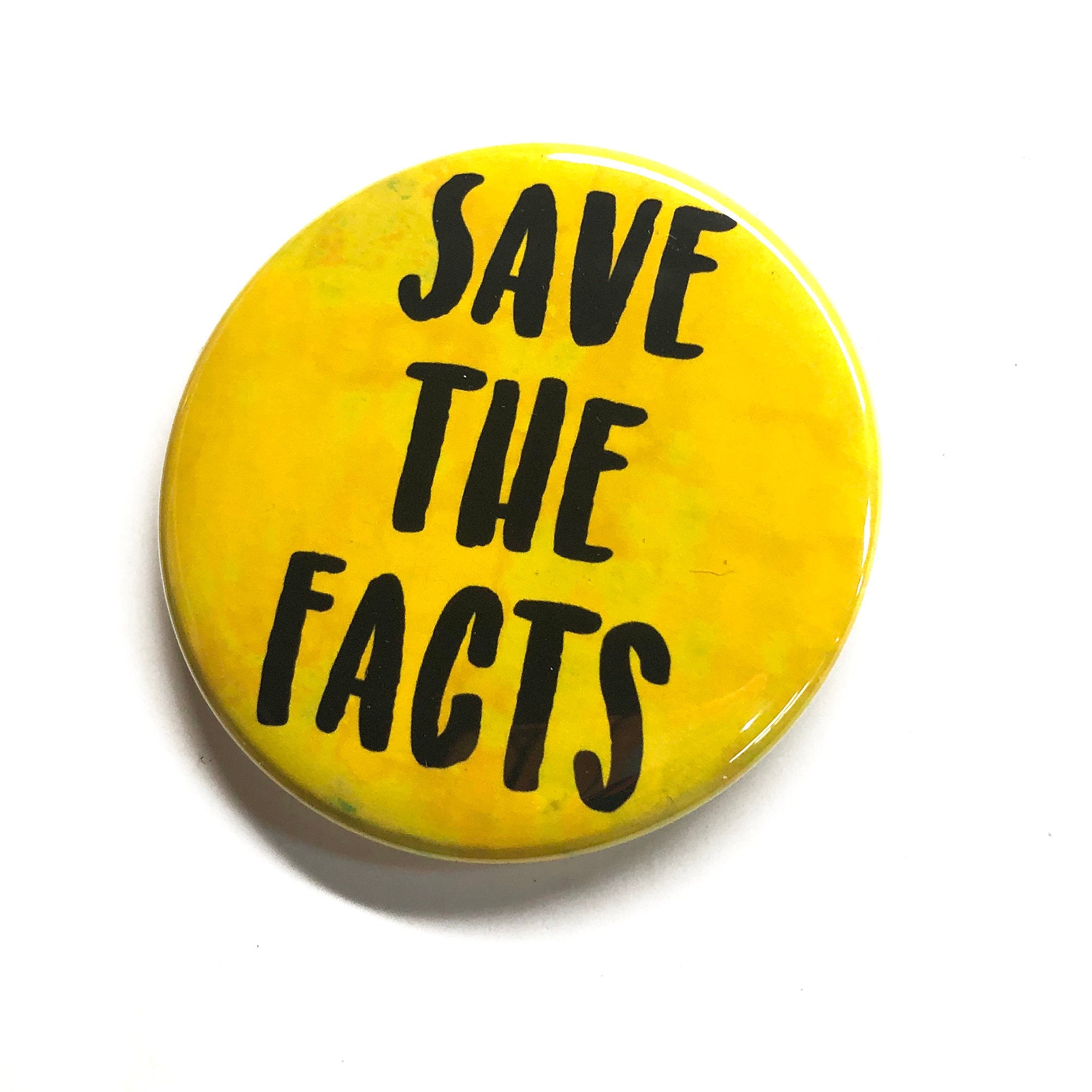 yellow button with the words Save the Facts in black