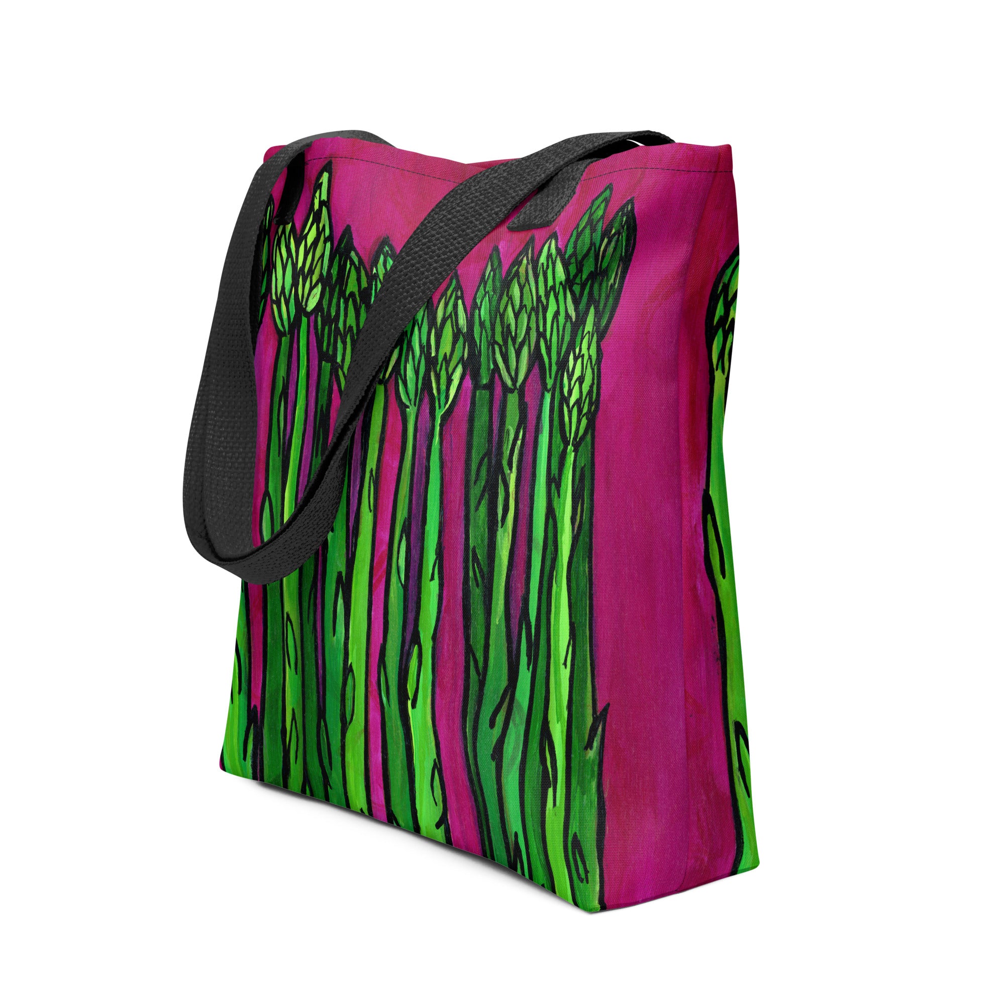 side view of saparagus tote bag with black straps. Green asparagus stalks are set on a deep magenta background on both sides of the bag.