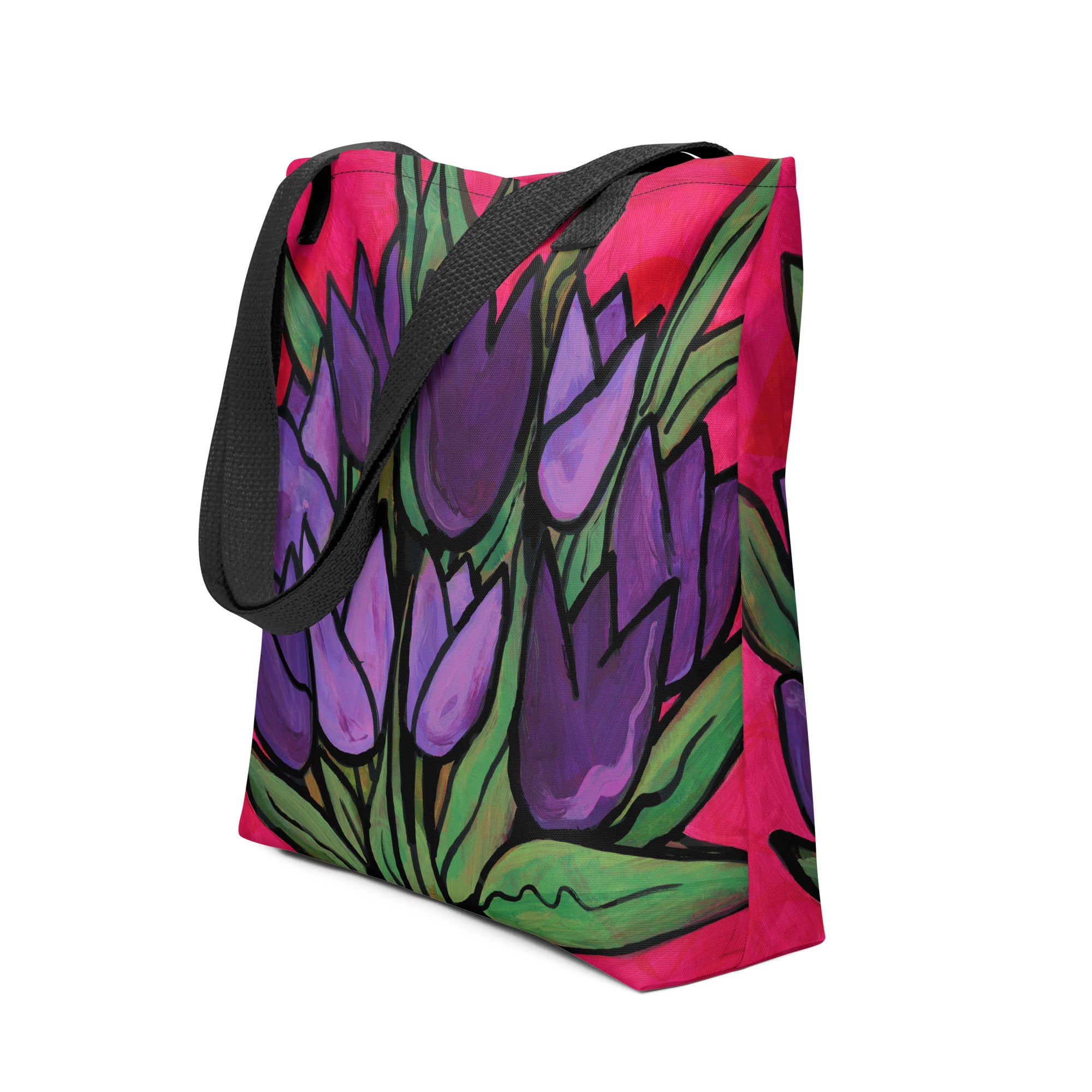 side view of Purple Tulip Passion Tote Bag with purple tulips and long green leaves on a magenta red background