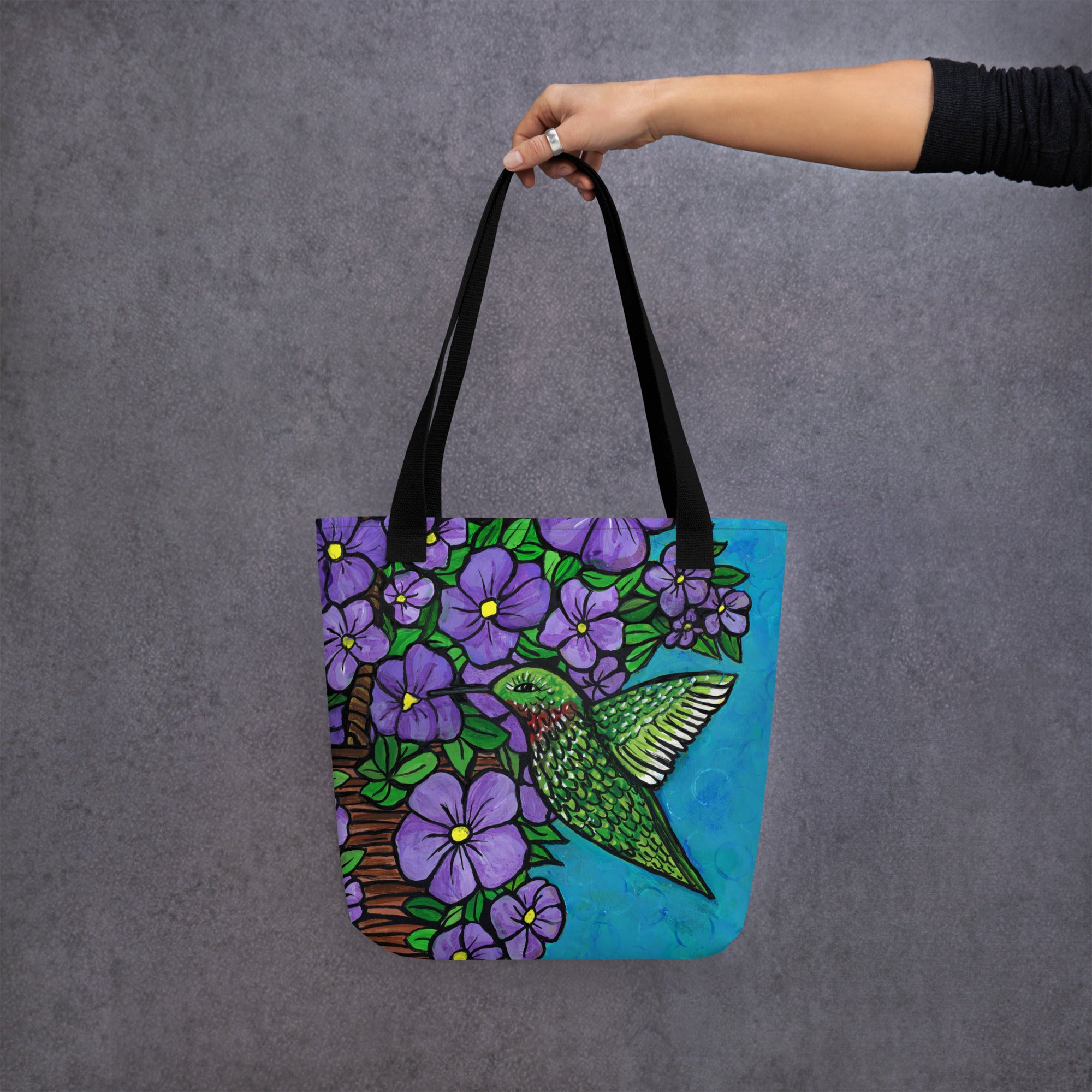 Outstretched arm holding Hummingbird Tote Bag