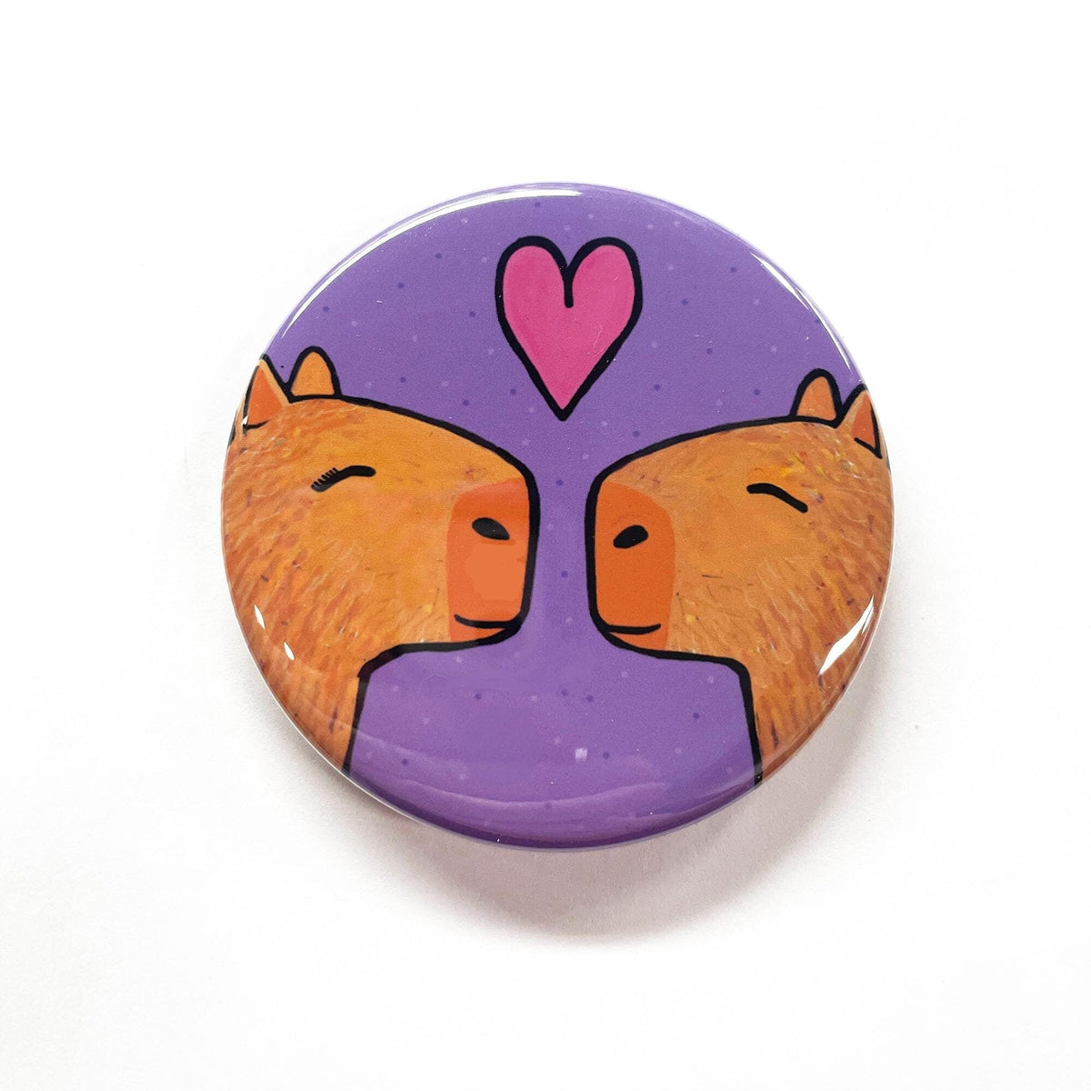 capybaras facing each other with eyes closed and a pink heart above them. purple background with small purple dots.