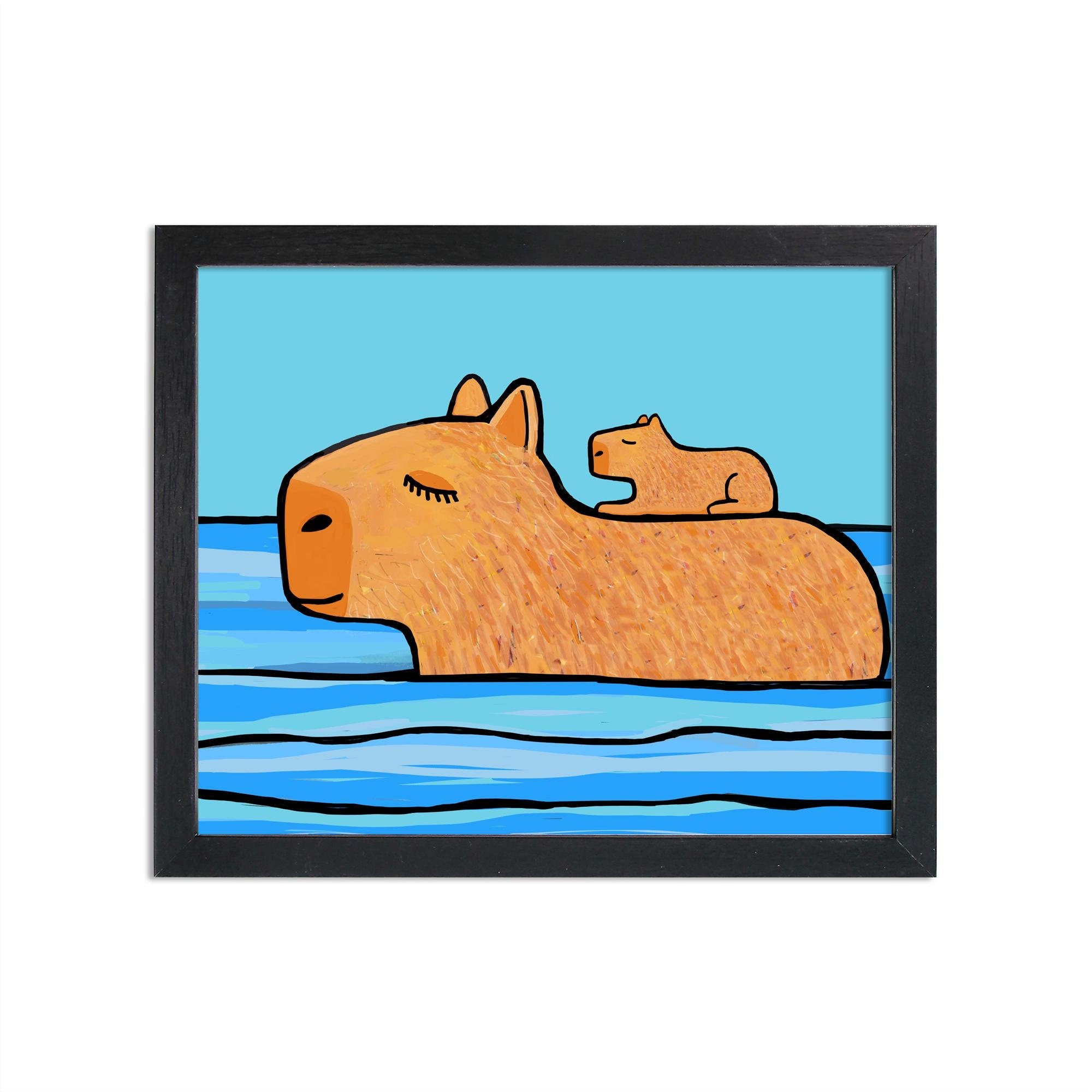 Capybara art print in black frame. Art features mother capybara with baby pup on her back as she swims through blue water with blue sky in the background.