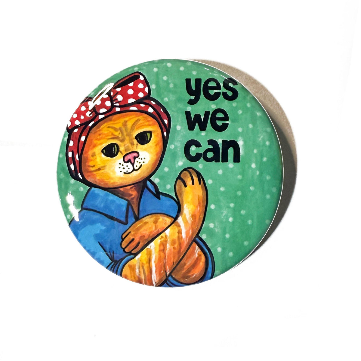 Round pin or magnet with cat dress as rosie the riveter with the words yes we can