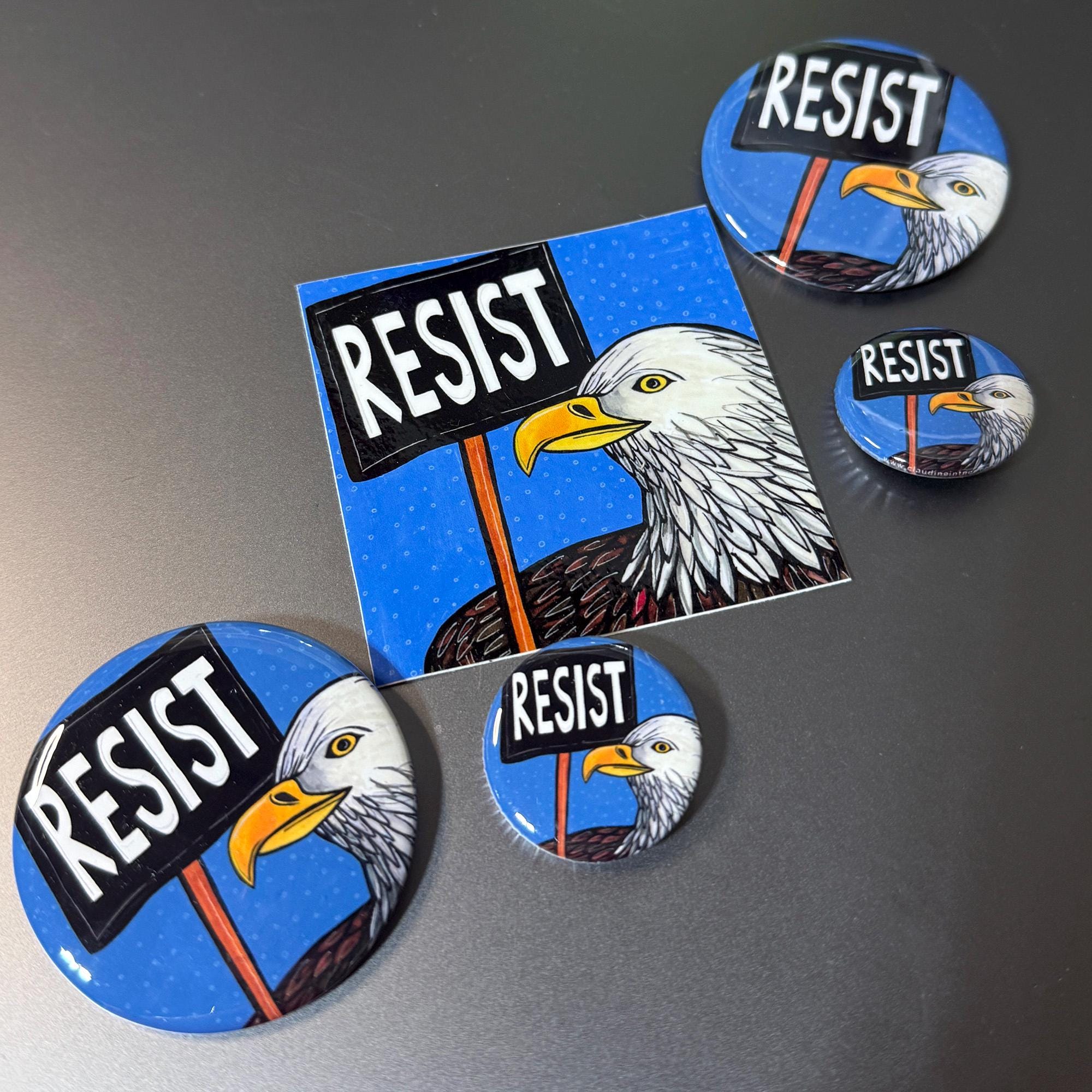 Bald Eagle Resist sticker is also available as 1.25 inch magnets and pins, 2.25 inch magnets and pins, and art prints.