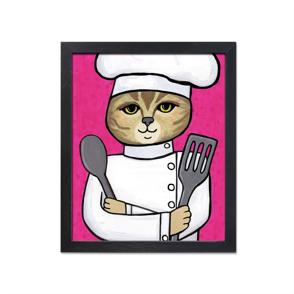 Cat Chef art print in a simple black frame. Art features an american shorthair cat in a chef's hat and jacket holding metal spoon and spatula on a pink background