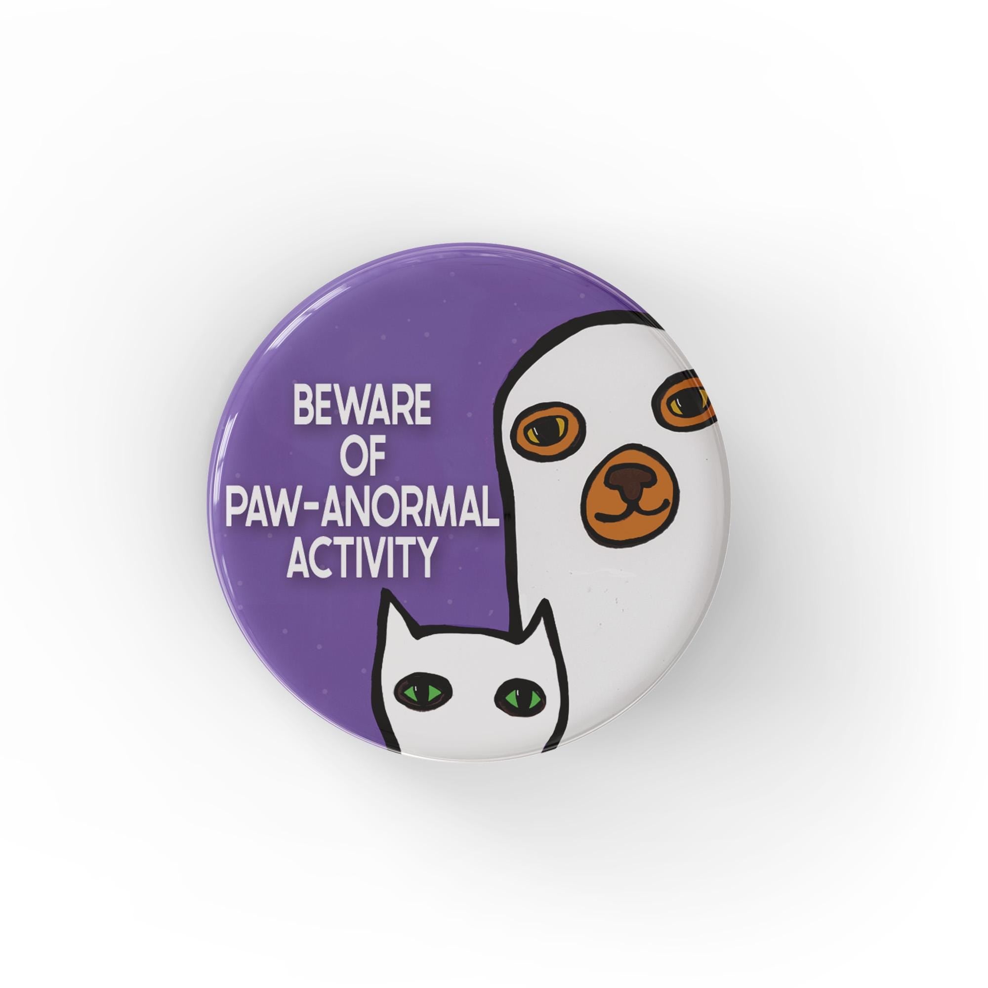 round purple button with the words Beware of Paw-anormal Activity and a cat and dog with white ghost costumes