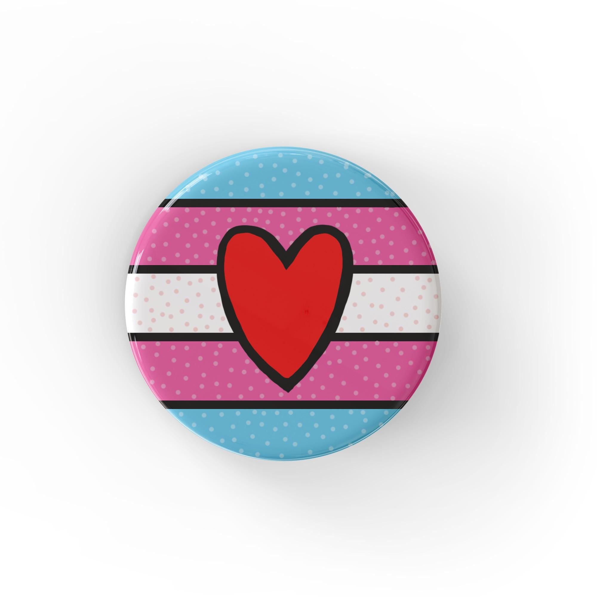 Round trans flag pin or magnet with a red hand drawn heart in the center