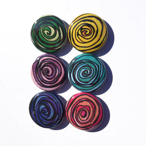 set of colorful rose magnets or pins on white background