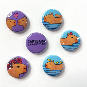 Capybara magnet or pin set - 6 designs including capybara is friend to all on purple, capybara with apple on head in the water, capybaras in love with heart, baby capybara riding on his swimming mom, capybara with rose crown, and capybara with birds