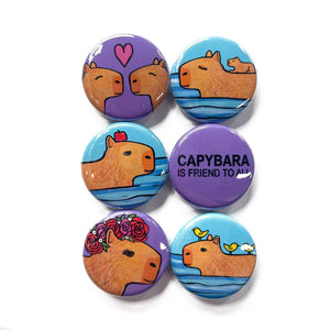 Capybara magnet or pin set - 6 designs including capybara is friend to all on purple, capybara with apple on head in the water, capybaras in love with heart, baby capybara riding on his swimming mom, capybara with rose crown, and capybara with birds