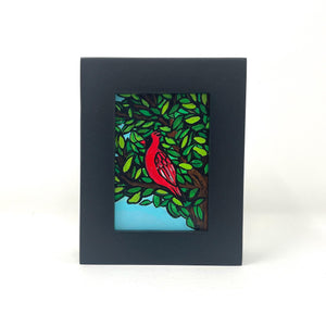 Small framed painting of a cardinal in a tree