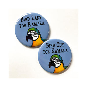 Round pin with the words Bird Lady for Kamala and macaw on blue and round pin with words Bird Guy for Kamala on blue with macaw