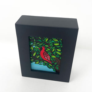 view of chunky black frame with cardinal painting