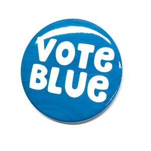 circular button with the words vote blue in white on a blue wave background