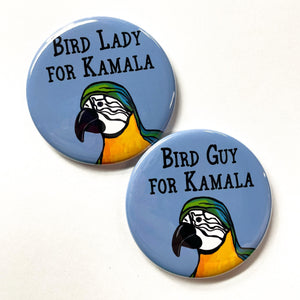 Round pin with the words Bird Lady for Kamala and macaw on blue and round pin with words Bird Guy for Kamala on blue with macaw