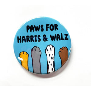 Round blue button with the words Paws for Harris & Walz in black with 4 different animal paws