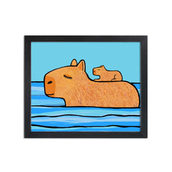 Capybara art print in black frame. Art features mother capybara with baby pup on her back as she swims through blue water with blue sky in the background.