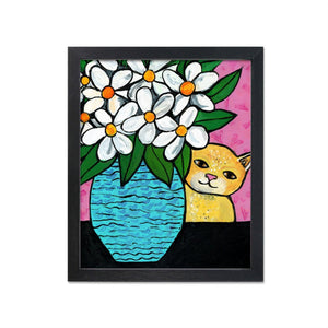 Yellow tabby cat hiding behind blue vase with white daisies and leaves. Black table.Pink background with light heart pattern.