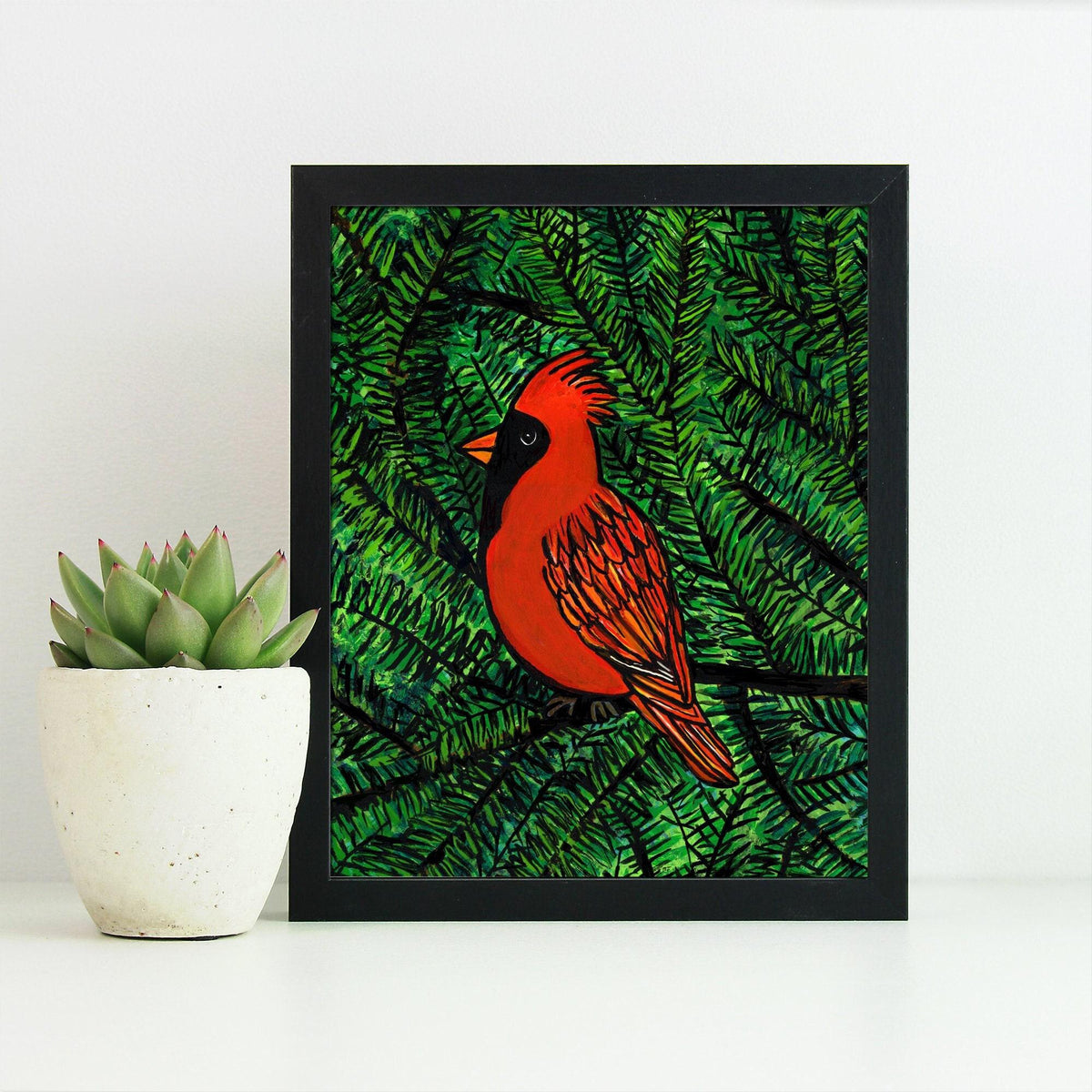 Red cardinal in green pine tree