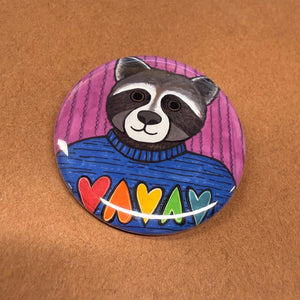 Roxy Raccoon pin on brown background