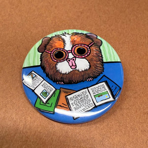 Ginger the Guinea Pig button shown on a brown background