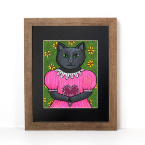 Jane the Black Cat art print shown in a brown frame with black mat