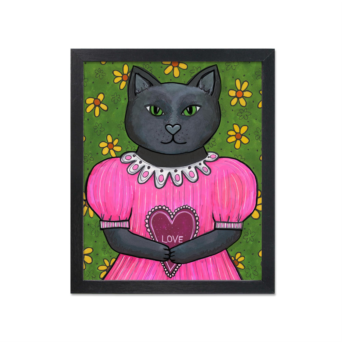 Jane the Black Cat art print in black frame - design features a black cat in a pink puffy dress holding a love heart. She stands against a green floral wall with yellow flowers.