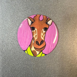 Round button of a giraffe in a bright green shirt on a pink striped background