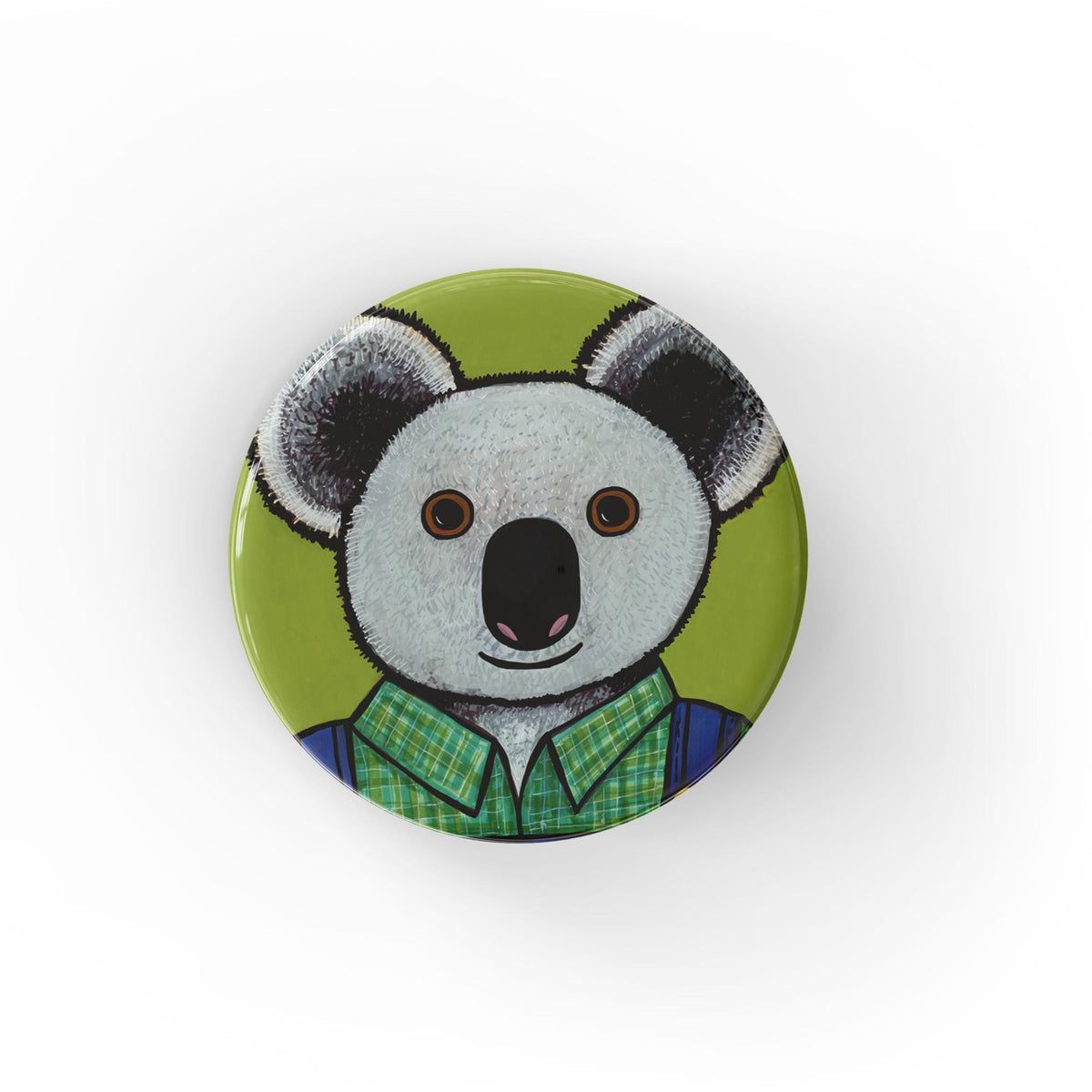 Round koala bear pin or magnet featuring Oliver the Koala in green plaid shirt and blue overalls on a bright green background.