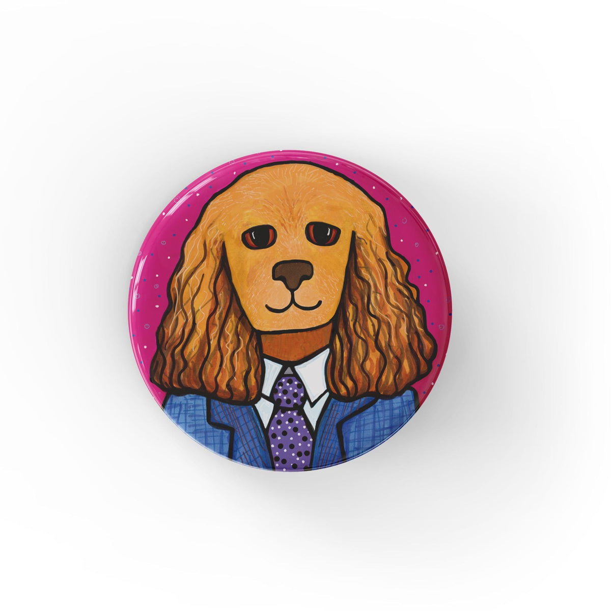 Round button with a cocker spaniel in a blue suit with purple tie and white shirt on a pink backfround. Available as pins and magnets.