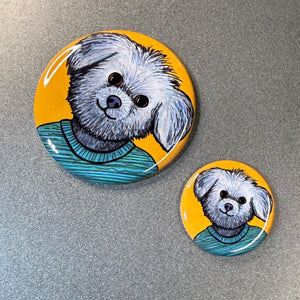 view of the two different sizes of Millie the Shih Tzu pins and magnets - 2.25 inch and 1.25 inch