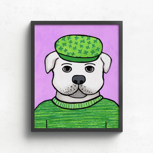 art print featuring a white bulldog in a green sweater and green cap with a light purple background. shown in a black frame on a white wall.