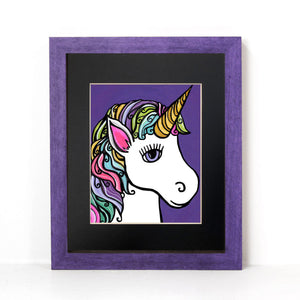 Unicorn art print shown in a purple frame with black matte on a white wall. The unicorn is shown in profile with rainbow hair on a purple background with tiny starts.