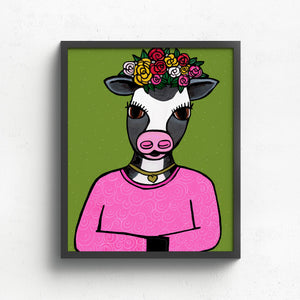 art print featuring a cow in pink shirt, gold heart necklace, and flower crown on a green background