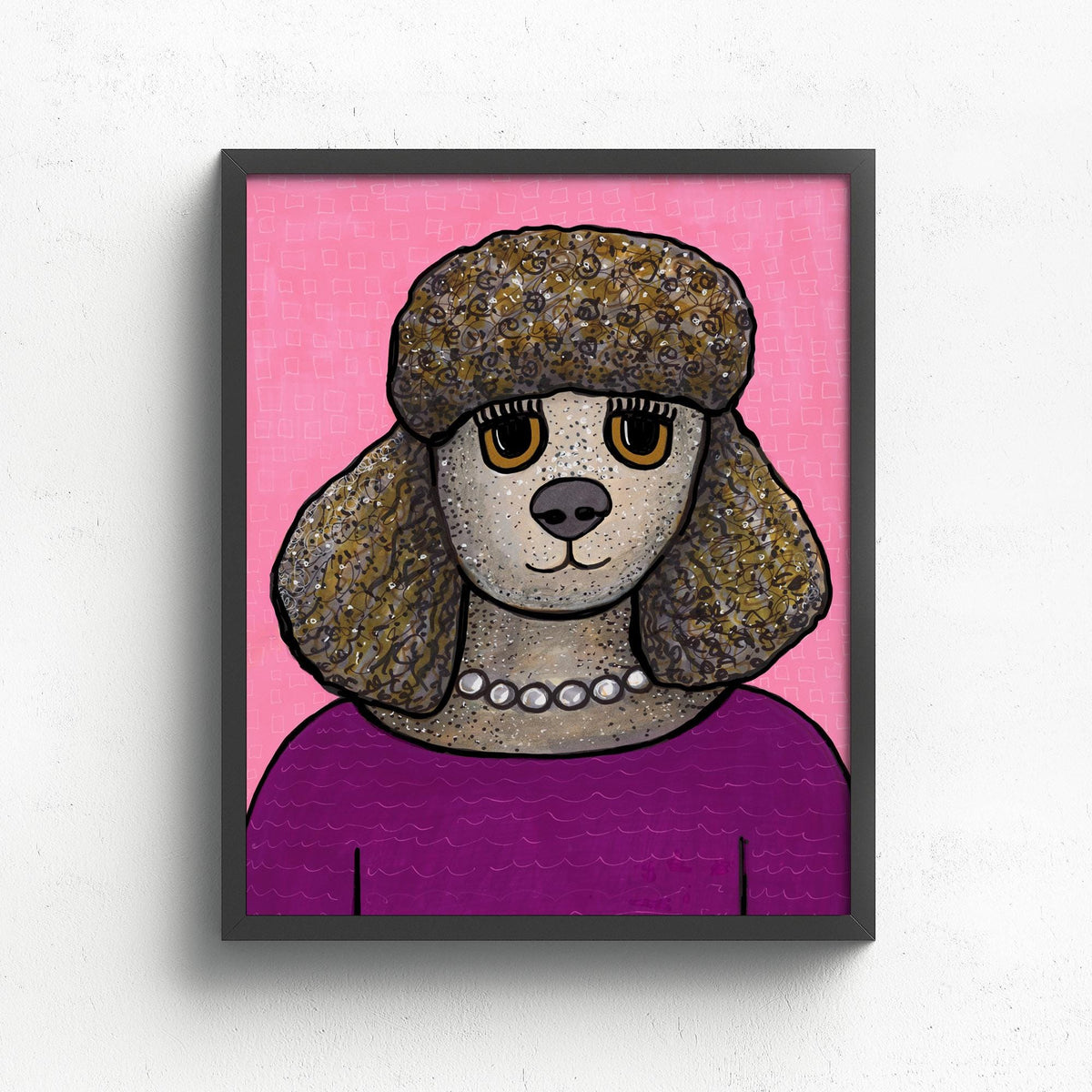 art print featuring Penelope the Poodle. Dog is wearing a magenta top with white pearl necklace. The background is pink with small rectangle pattern. Print is shown in a black frame on a white wall.