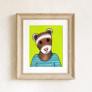 Daisy the Ferret art print shown in a light brown wood frame and white matte on a white background