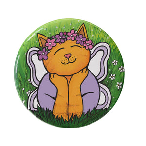 Chloe the Cat Fairy button features a yellow tabby cat laying in the grass with her head resting on her paws. She has a pink and purple flower crown, purple shirt, and purple and white wings.