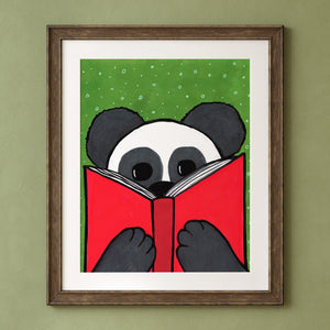 Mandy Panda art print in a brown frame with white mat on a green background.