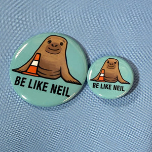2.25 inch and 1.25 inch buttons of BE LIKE NEIL design for size comparison on a blue background