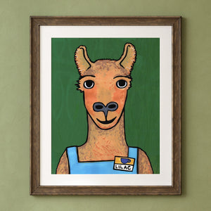 8x10 art print of Lilac Llama the Barista - brown llama looking straight at the viewer. They are wearing a blue apron and a name tag that says Lilac with a coffee cup. The background is green with subtle wavy vertical lines. Shown in a wood frame with white mat on a green wall. Frame is not included.