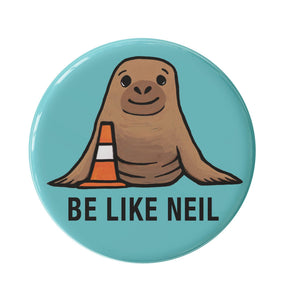 round turquoise button with hand drawn elephant seal - Neil the Seal - with a orange traffic cone and the words BE LIKE NEIL