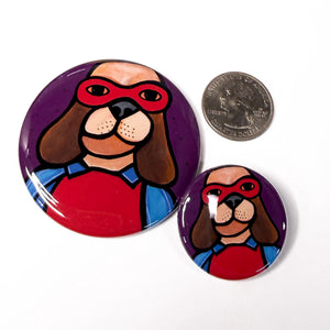 2.25 inch and 1.25 inch round buttons compared to a US quarter