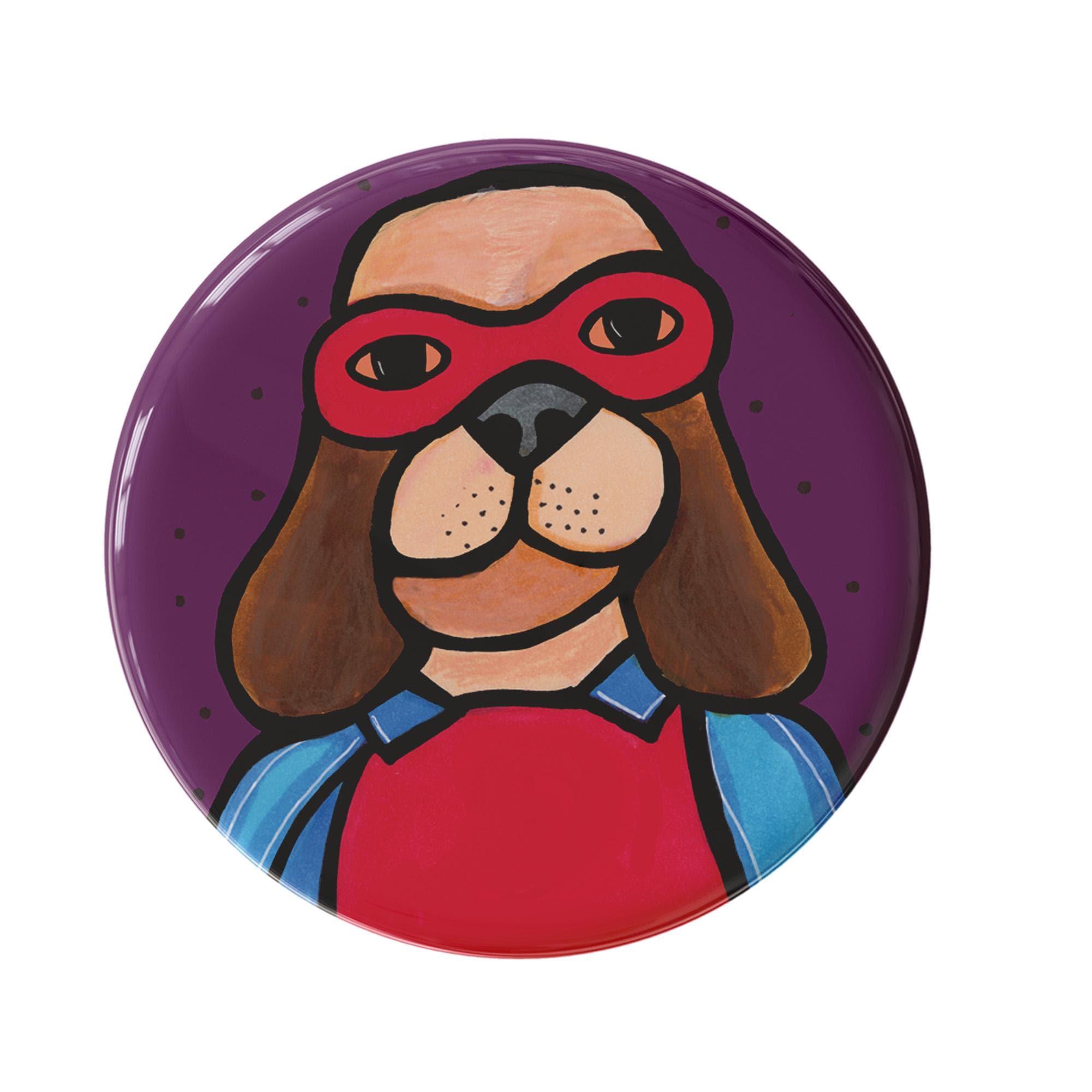 round button with super hero dog - brown dog with red mask, red shirt, and blue cape on a purple background