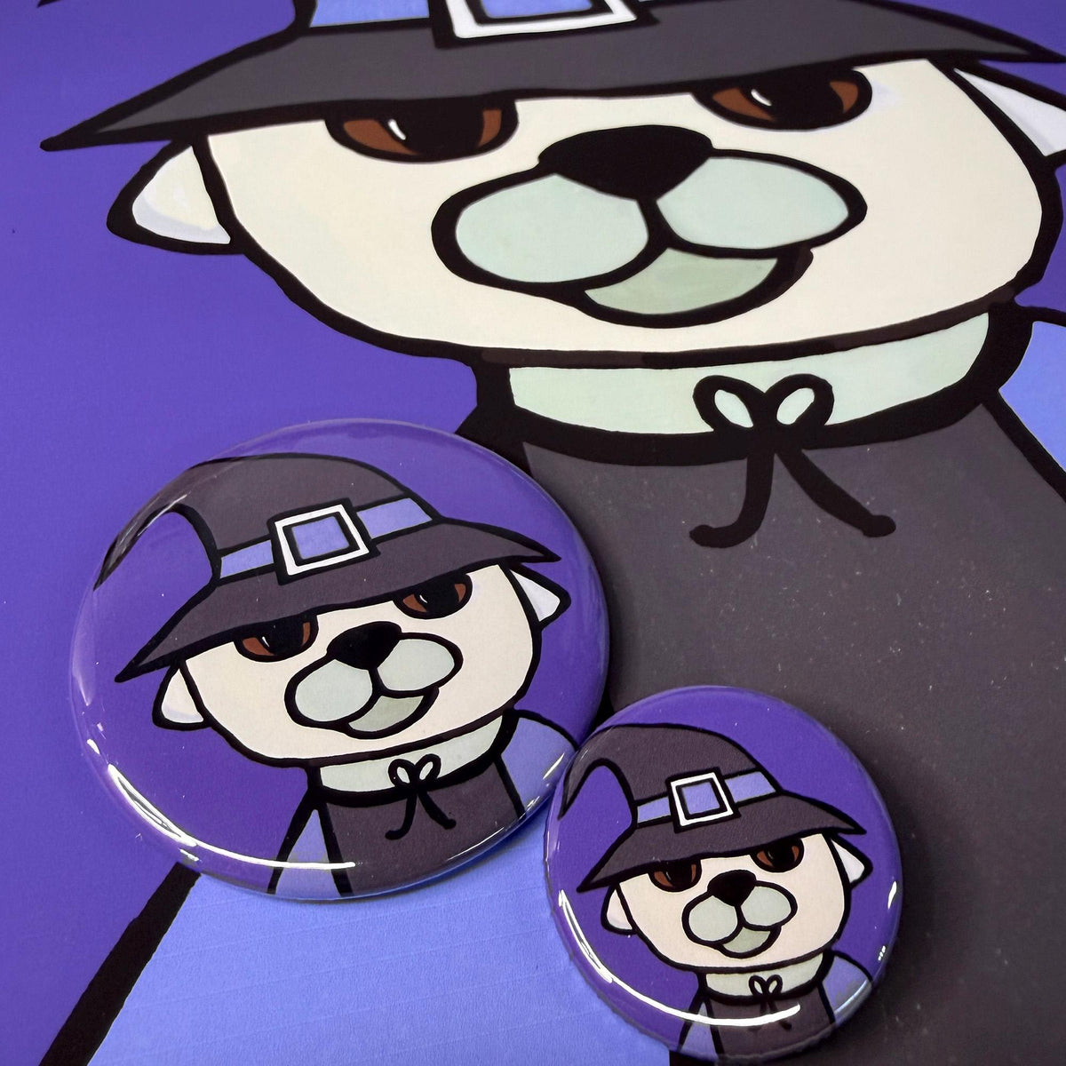 round Witch Dog buttons shown on a Witch Dog print