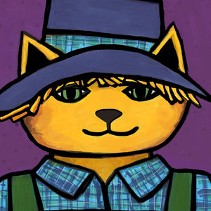 close up of Scarecrow Cat's face featuring green eyes, straw sticking out from his hat, and yellow orange fur