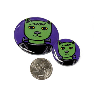 2.25 and 1.25 inch Frankencat buttons compared to a US quarter coin