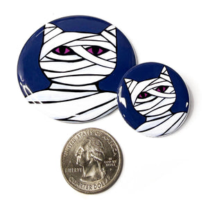 2.25 inch and 1.25 inch Cat Mummy buttons compared to a US quarter