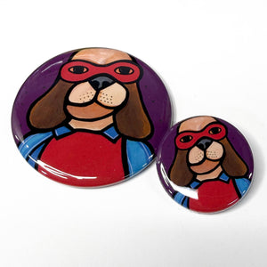 super hero dog button shown in both sizes on white