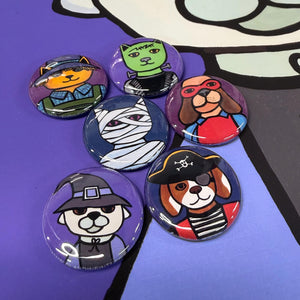 Halloween cat and dog costume magnets and pins shown on a print of the dog witch