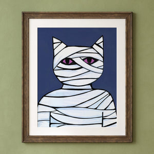 Cat Mummy shown in a wood frame with white mat on a green wall